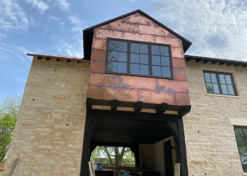 Copper metal panel facade on a stone building for Metal Roof Coating in Murrieta